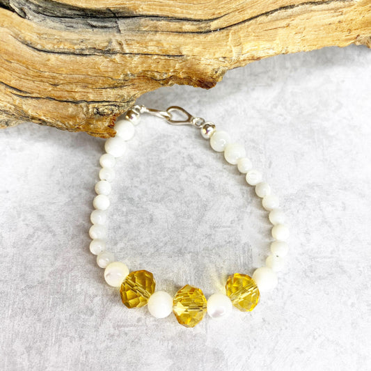 Joyous Prosperity Gemstone Bracelet. Faceted Citrine and Mother of Pearl Beaded Bracelet. Mother of pearl beads with 3 citrine beads in the middle, separated by mother of pearl beads.