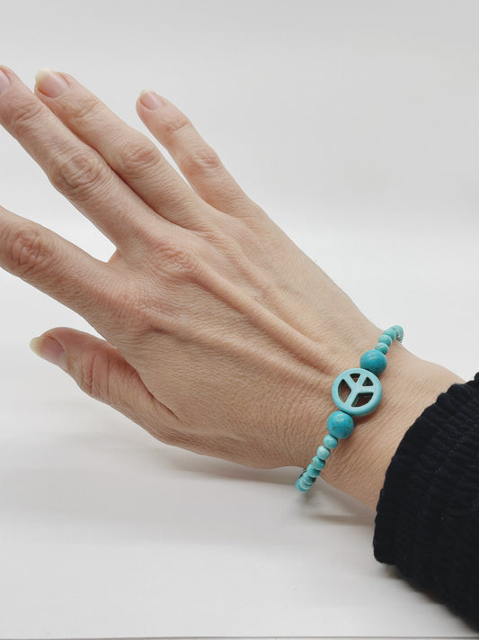 Crystal Gemstone Beaded Peace Blue Bracelet. Turquoise, Turquenite and Sterling Silver. Blue with a blue peace charm in the middle.