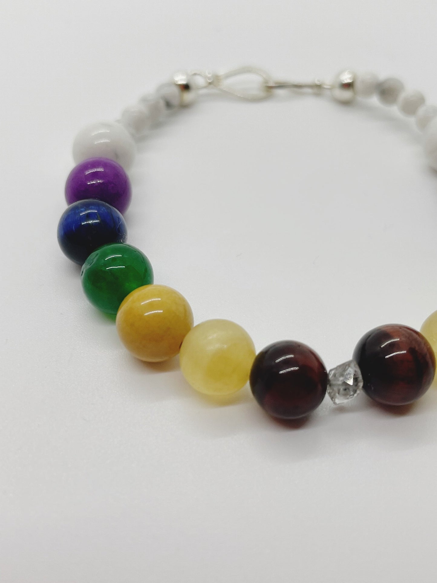 Crystal Beaded Chakra Bracelet.  Herkimer Quartz, Red & Blue Tiger’s Eye, Yellow Calcite,  Mookaite, Green Chalcedony, Sugalite, Sterling Silver