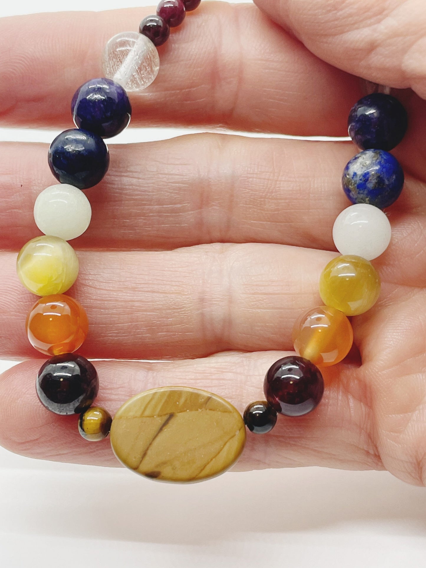 Crystal Bead Chakra Bracelet. Picture Jasper, Tiger’s Eye, Garnet, Carnelian, Yellow Tiger’s Eye, Cave Calcite, Lapis, Charoite, Tourmaline